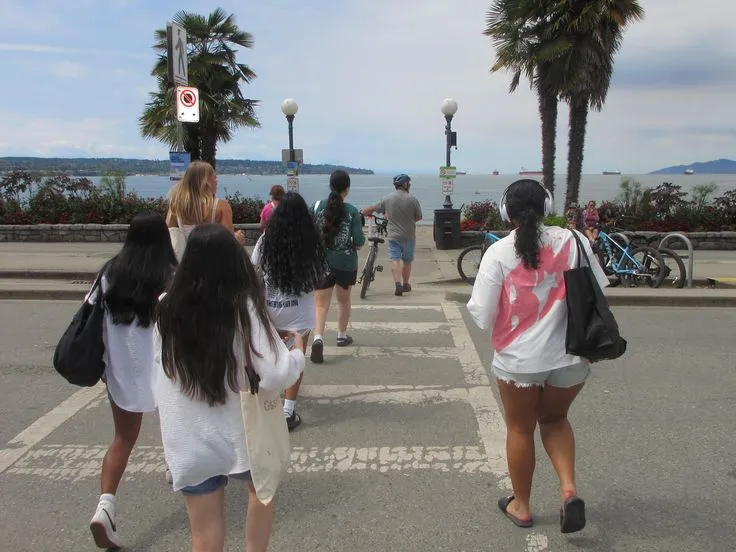 Group walking along a tree-lined trail